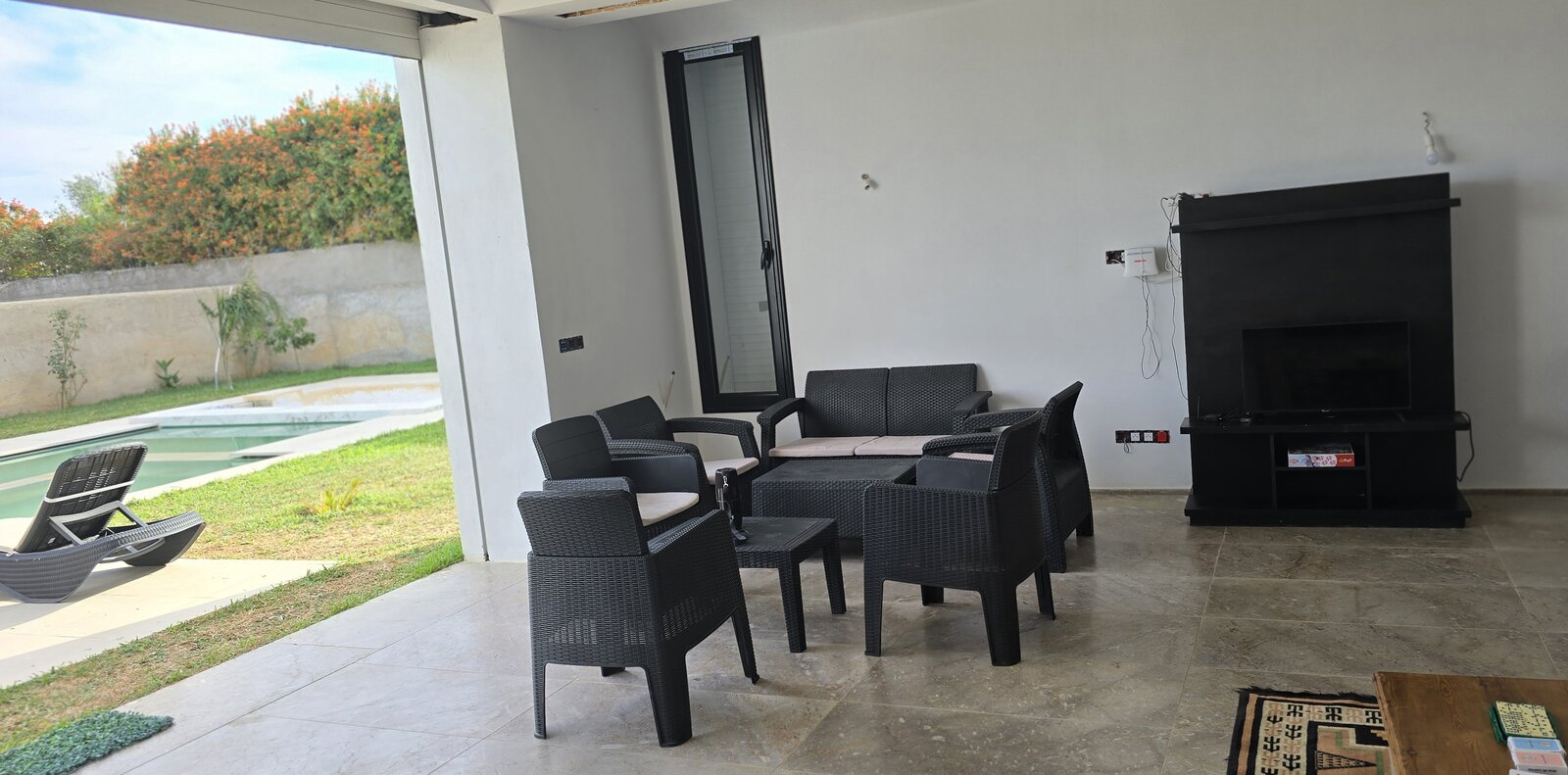 Salon avec TV ouvert sur la piscine, villa Dar Sekia